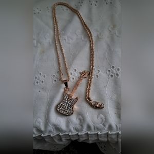 A  long guitar necklace.